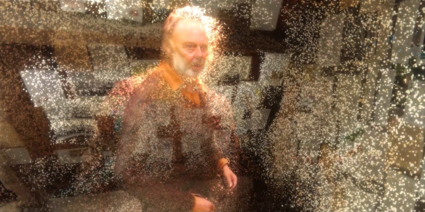 Still from Touched by a hologram?: a hologram of a man dissolving into particles